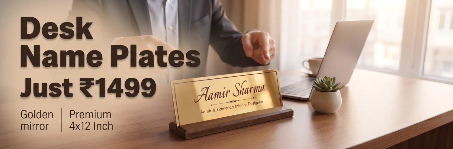 Premium golden mirror finish acrylic desk name plate on solid dark wood base displayed on an executive office workstation with laptop